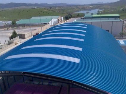 Self-supporting curved roofing of a municipal facilites in   Mejorada del Campo (Madrid) - Spain